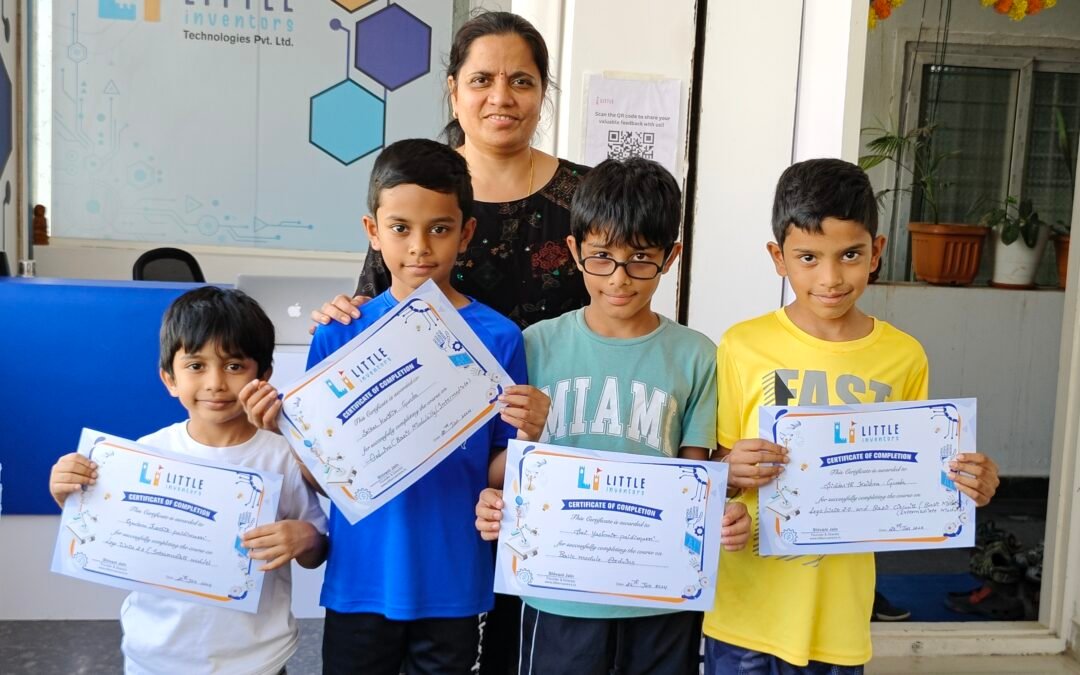 Kids receiving the completion certification of their courses at little inventors